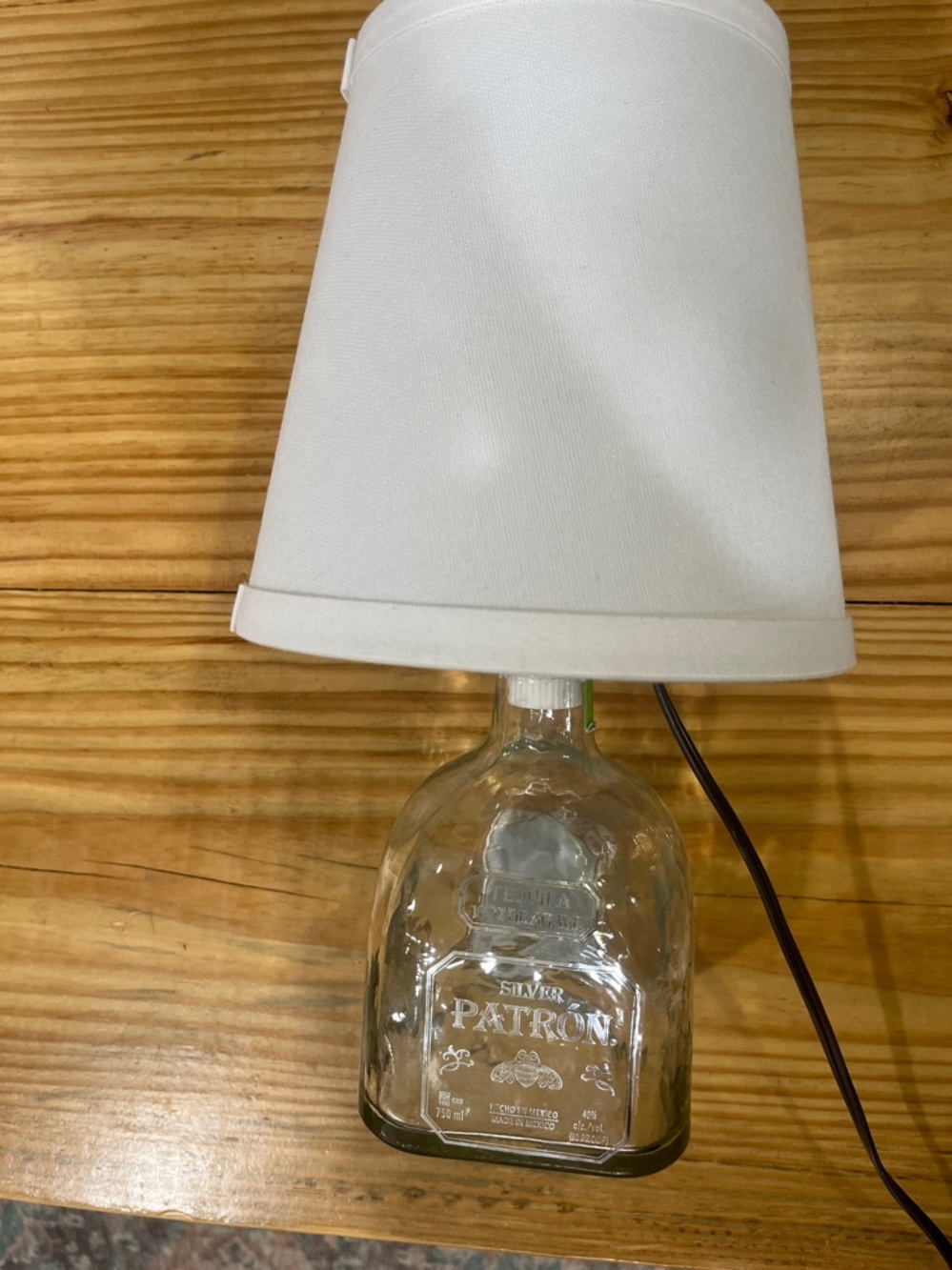 Hand Crafted Glass Patron Bottle Lamp White Shade. Approx 13” tall. Shade 7”